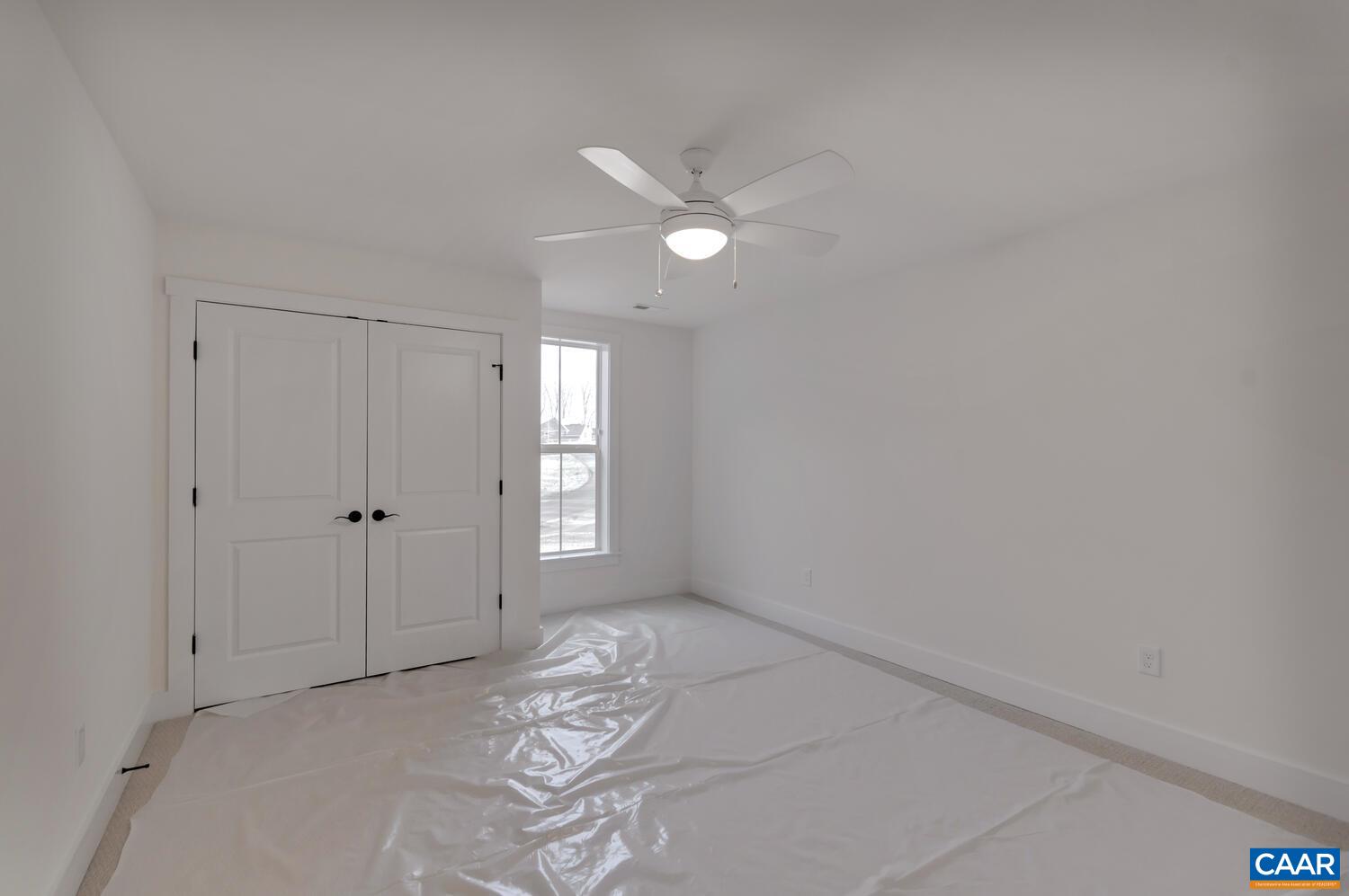 2 Jarmans Gap Road, Unit LOT 2 JARMANS GAP Crozet, VA 22932 - Photo 37 of 48 a view of a livingroom with an empty space and a ceiling fan