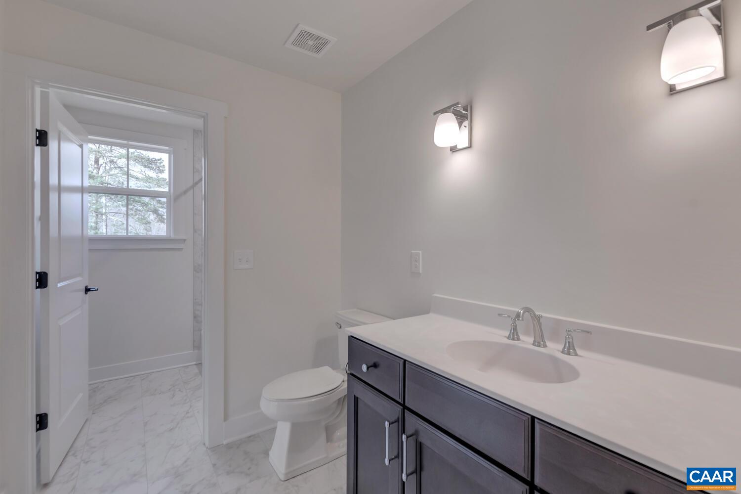 2 Jarmans Gap Road, Unit LOT 2 JARMANS GAP Crozet, VA 22932 - Photo 39 of 48 a bathroom with a toilet a sink a mirror and a window