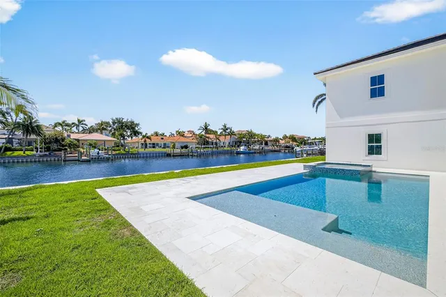 an aerial view of a house with a swimming pool patio and outdoor seating