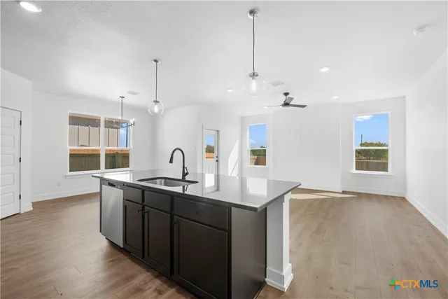 a kitchen with a sink and a stove