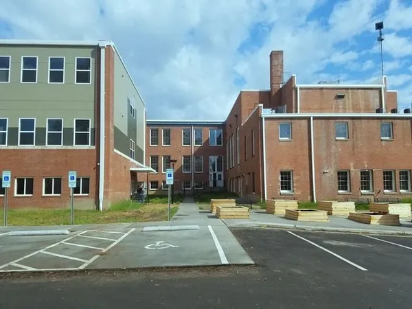 a view of a building with a yard