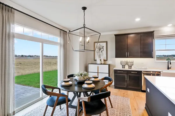 a kitchen with a table chairs stove and kitchen island
