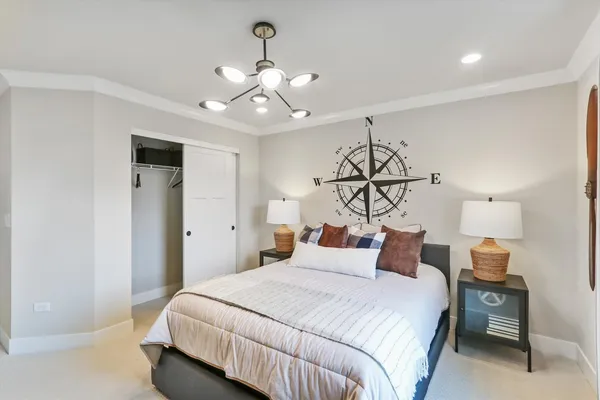 a bedroom with a large bed and a dresser