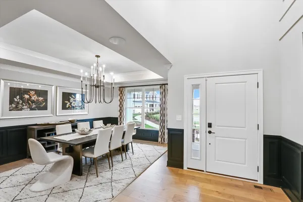 a view of a dining room with furniture and a chandelier