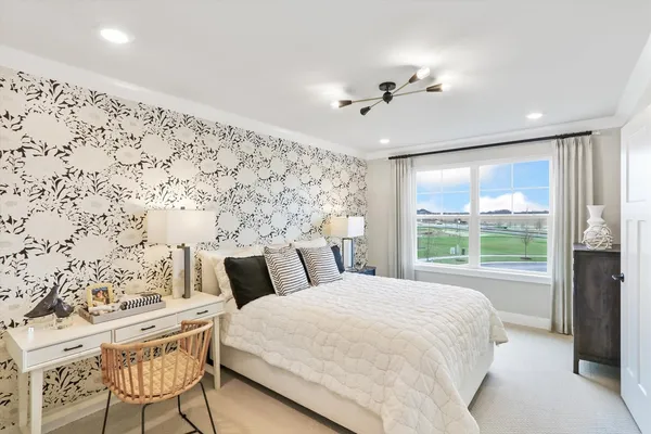 a bedroom with a large bed and a window