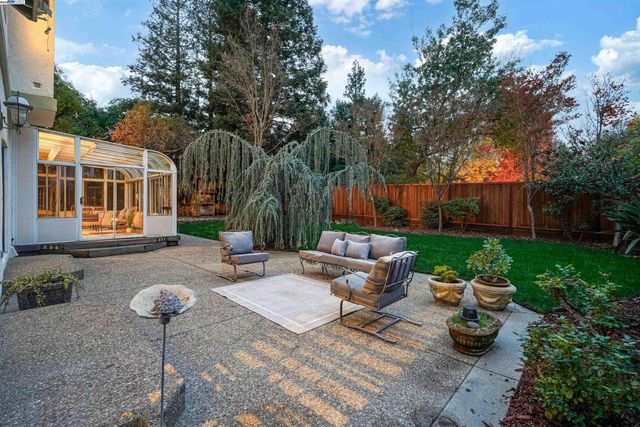 a backyard of a house with yard fire pit and outdoor seating
