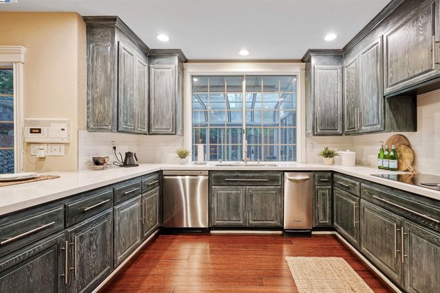 a kitchen with a sink stove and cabinets