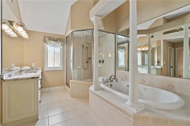 a bathroom with a tub a sink and mirror