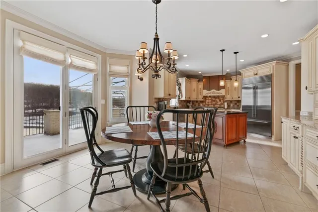 a view of a dining room with furniture and a chandelier