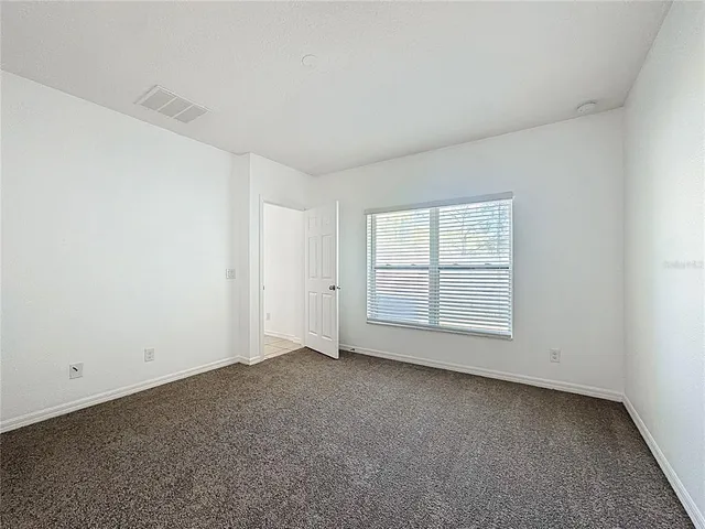 an empty room with a empty space and windows