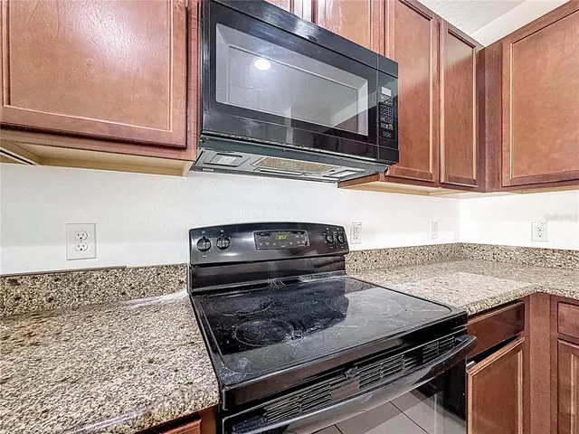 a stove top oven sitting inside of a kitchen