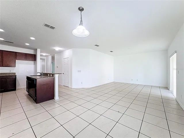 a kitchen with stainless steel appliances granite countertop a refrigerator a sink and a stove