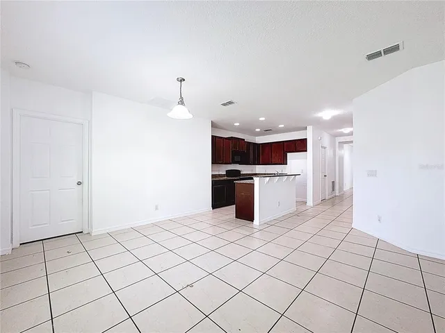 a kitchen with stainless steel appliances kitchen island granite countertop a refrigerator and a stove top oven