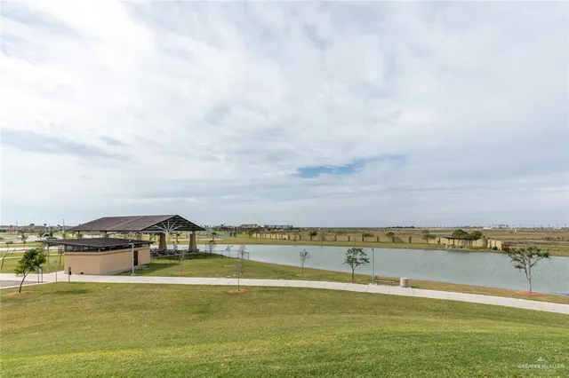 a view of a lake with houses in the back