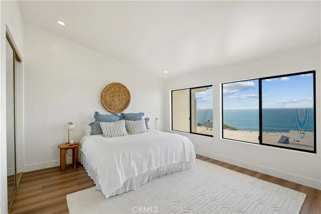 a bedroom with a large bed and a lamp on table