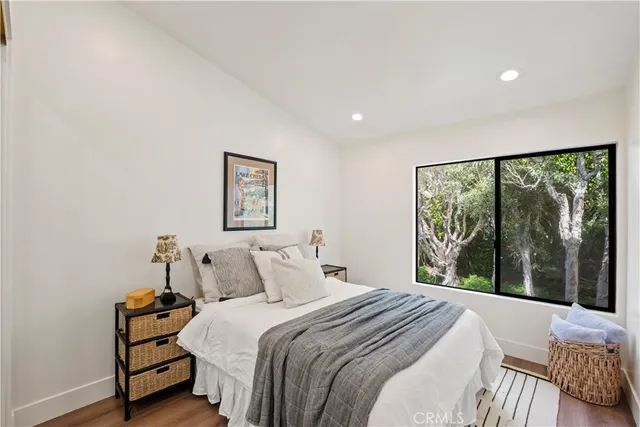 a bedroom with a large bed and a large window