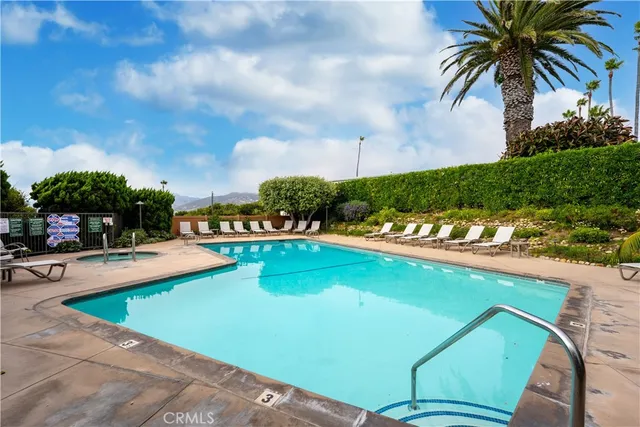 a view of a swimming pool and lounge chairs