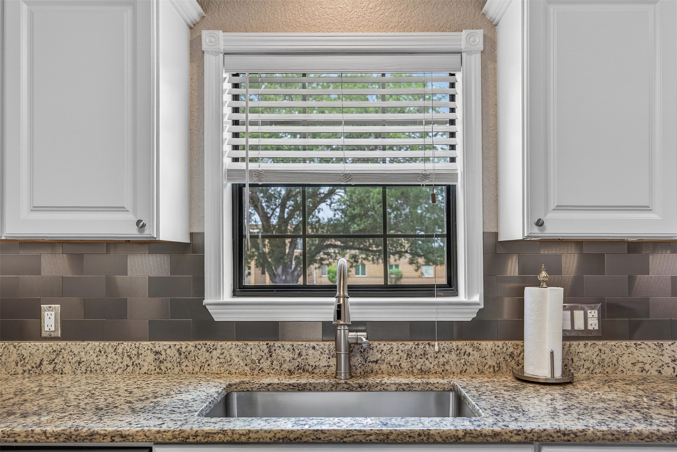 217 Walnut Avenue Luling, TX 78648 - Photo 12 of 38 a kitchen with granite countertop a sink and a window