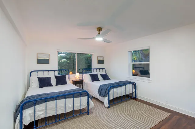 a bedroom with two beds and a window