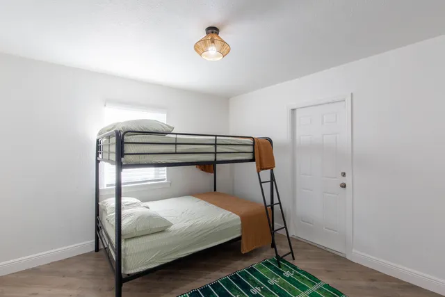 a bedroom with a bed and a chandelier