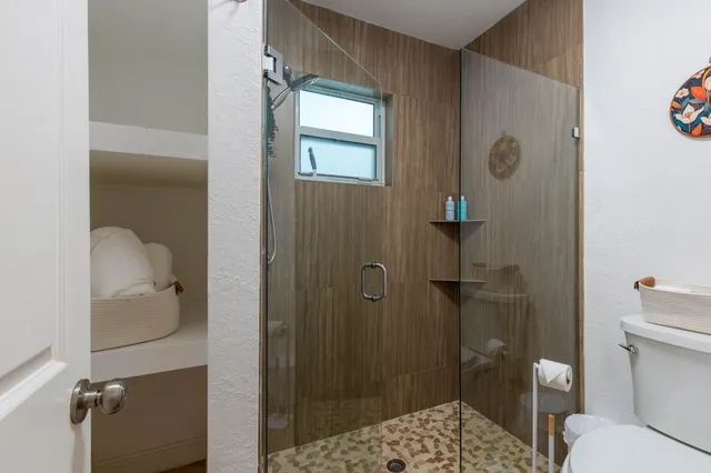 a bathroom with a shower toilet and sink
