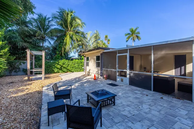 a view of house with backyard outdoor seating and entertaining space