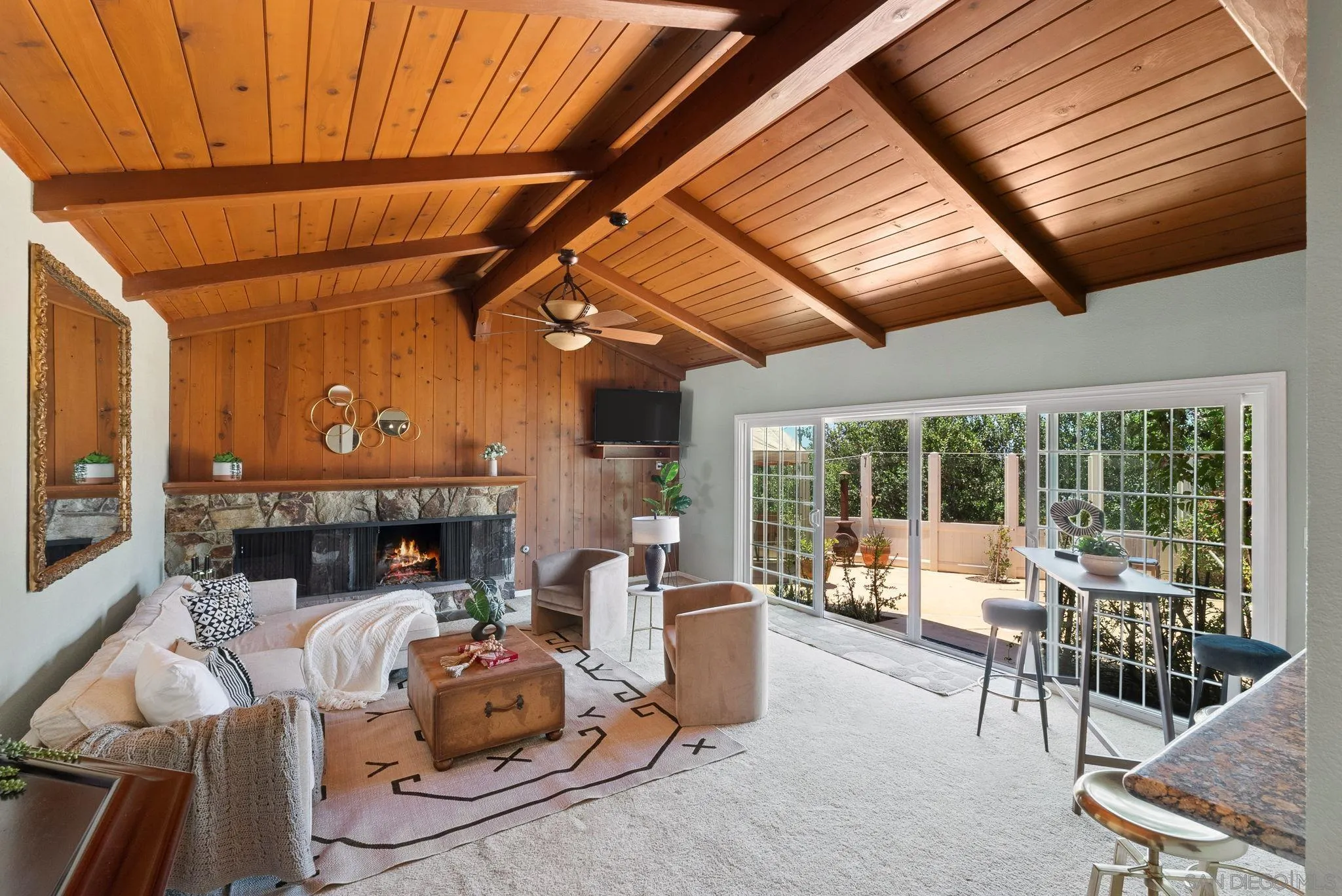 5492 Redding Road San Diego, CA 92115 - Photo 19 of 74 a living room with furniture a flat screen tv and floor to ceiling window