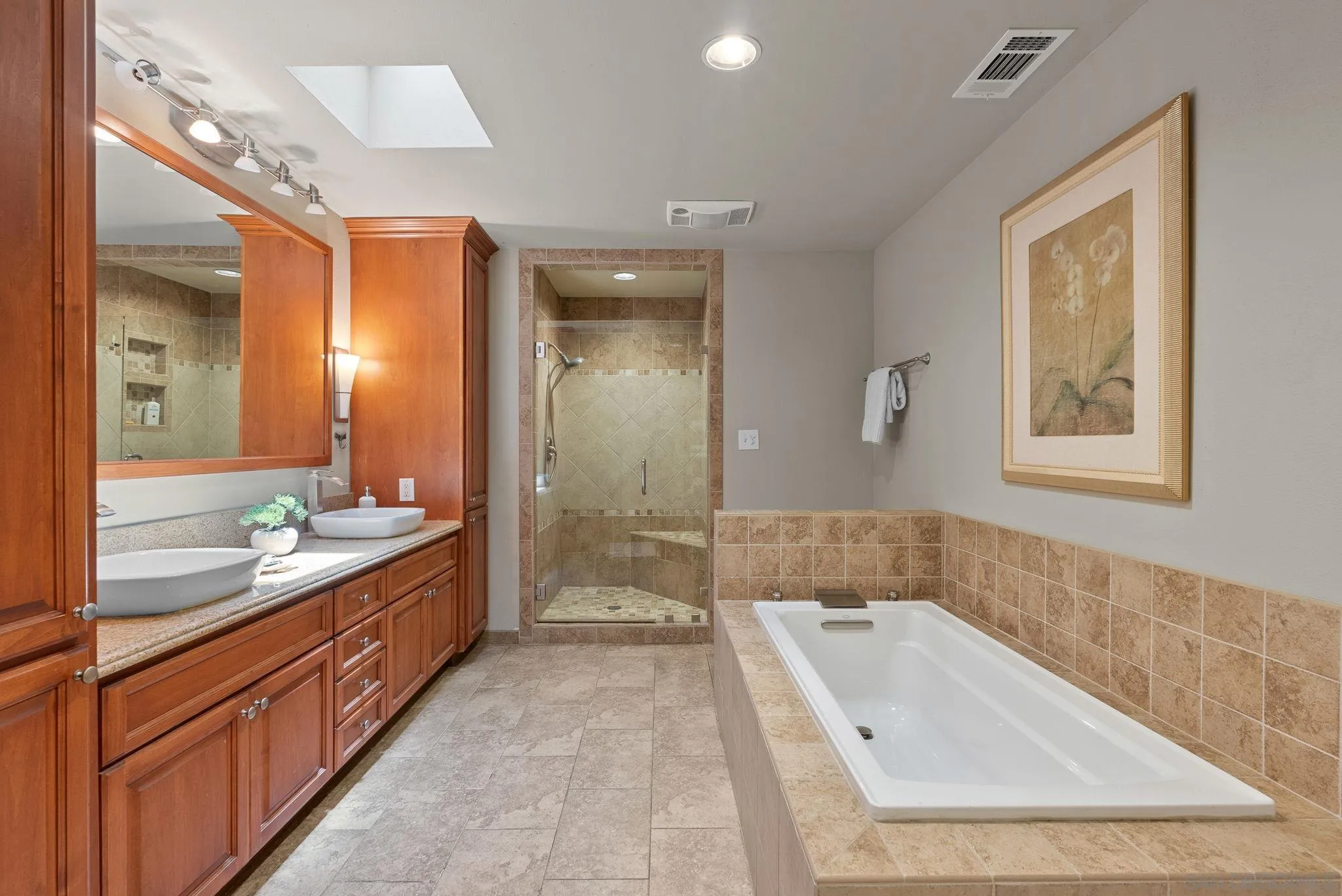 5492 Redding Road San Diego, CA 92115 - Photo 23 of 74 a bathroom with a tub a double vanity sink and mirror
