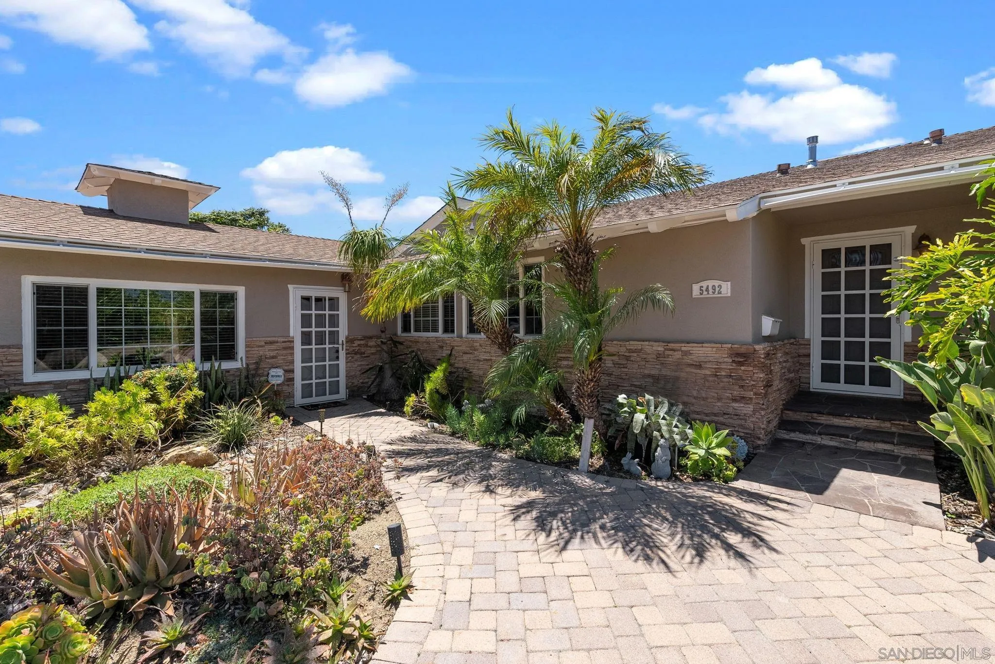 5492 Redding Road San Diego, CA 92115 - Photo 3 of 74 a front view of a house with garden