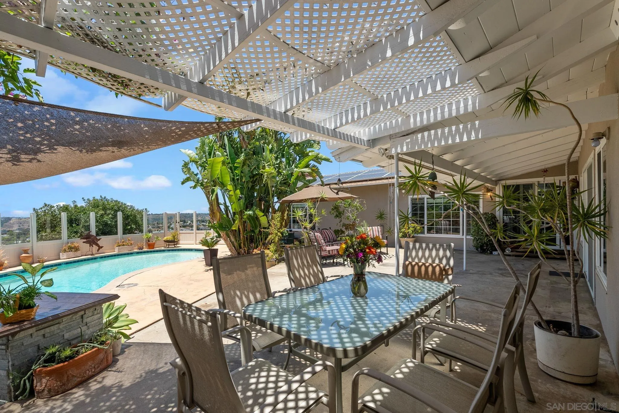5492 Redding Road San Diego, CA 92115 - Photo 37 of 74 a view of a patio with a table chairs and a potted plant