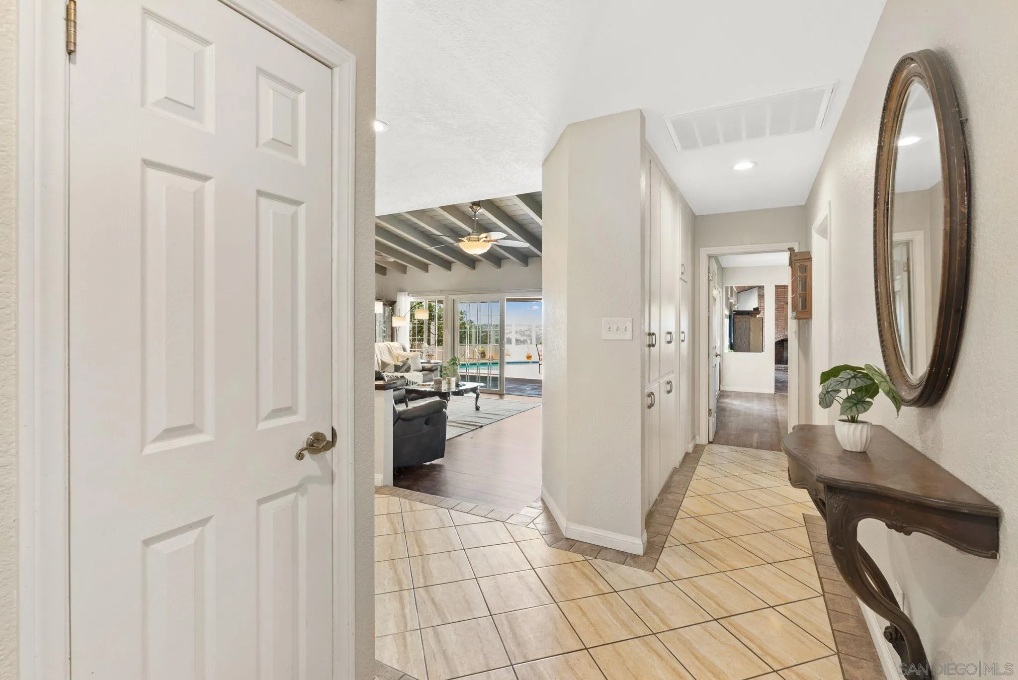 5492 Redding Road San Diego, CA 92115 - Photo 5 of 74 a view of a hallway with living room and furniture