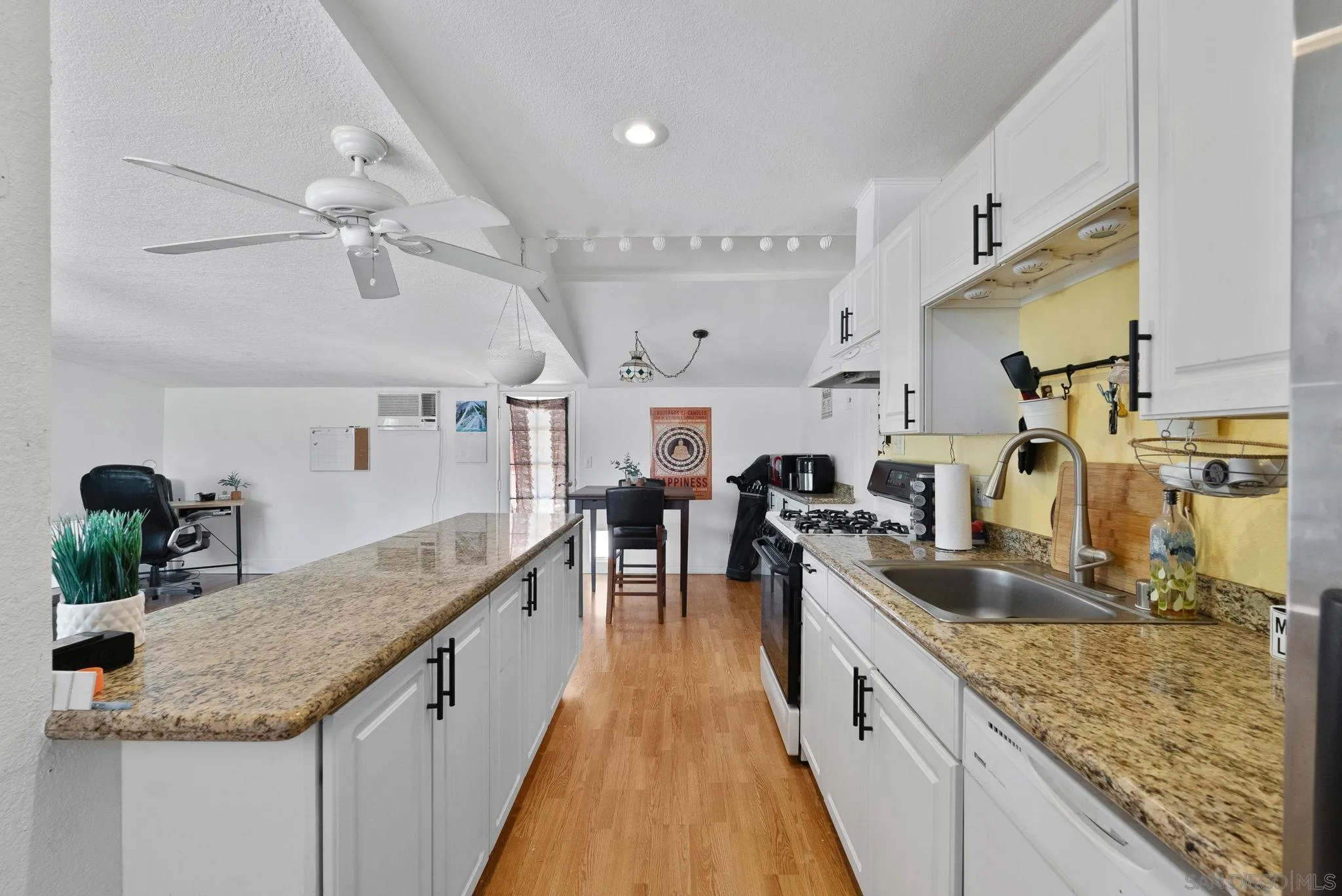 5492 Redding Road San Diego, CA 92115 - Photo 60 of 74 a kitchen with granite countertop a sink a counter top space appliances and cabinets