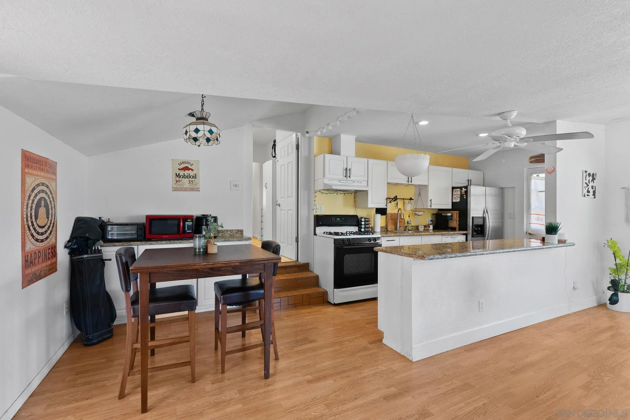 5492 Redding Road San Diego, CA 92115 - Photo 61 of 74 a kitchen with stainless steel appliances kitchen island granite countertop a refrigerator and a stove top oven