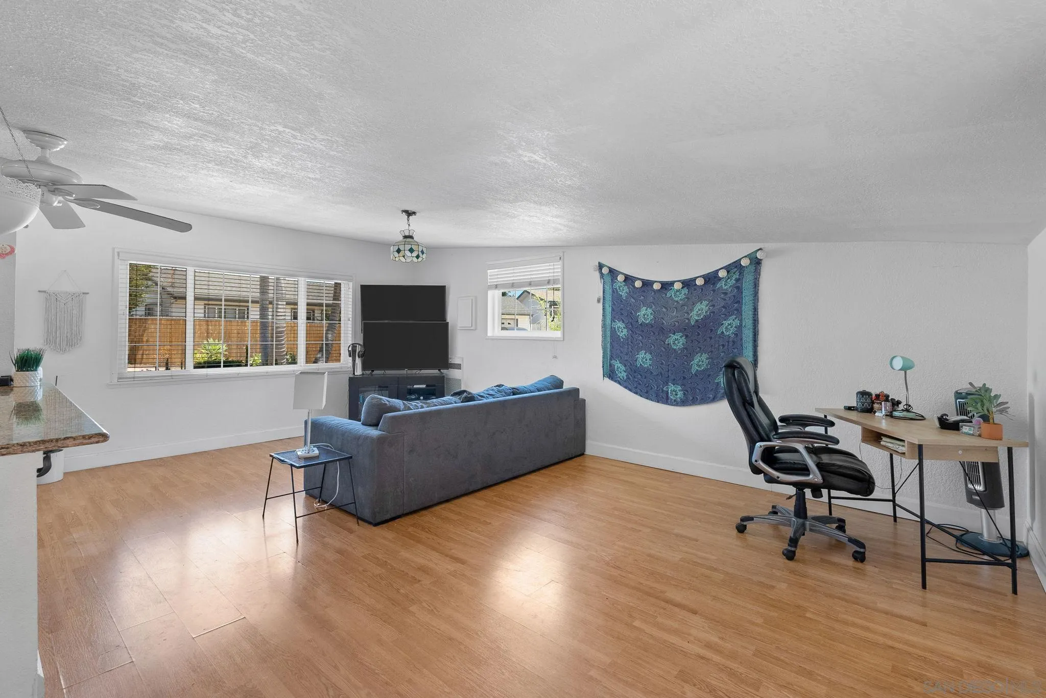 5492 Redding Road San Diego, CA 92115 - Photo 62 of 74 a living room with furniture and a flat screen tv