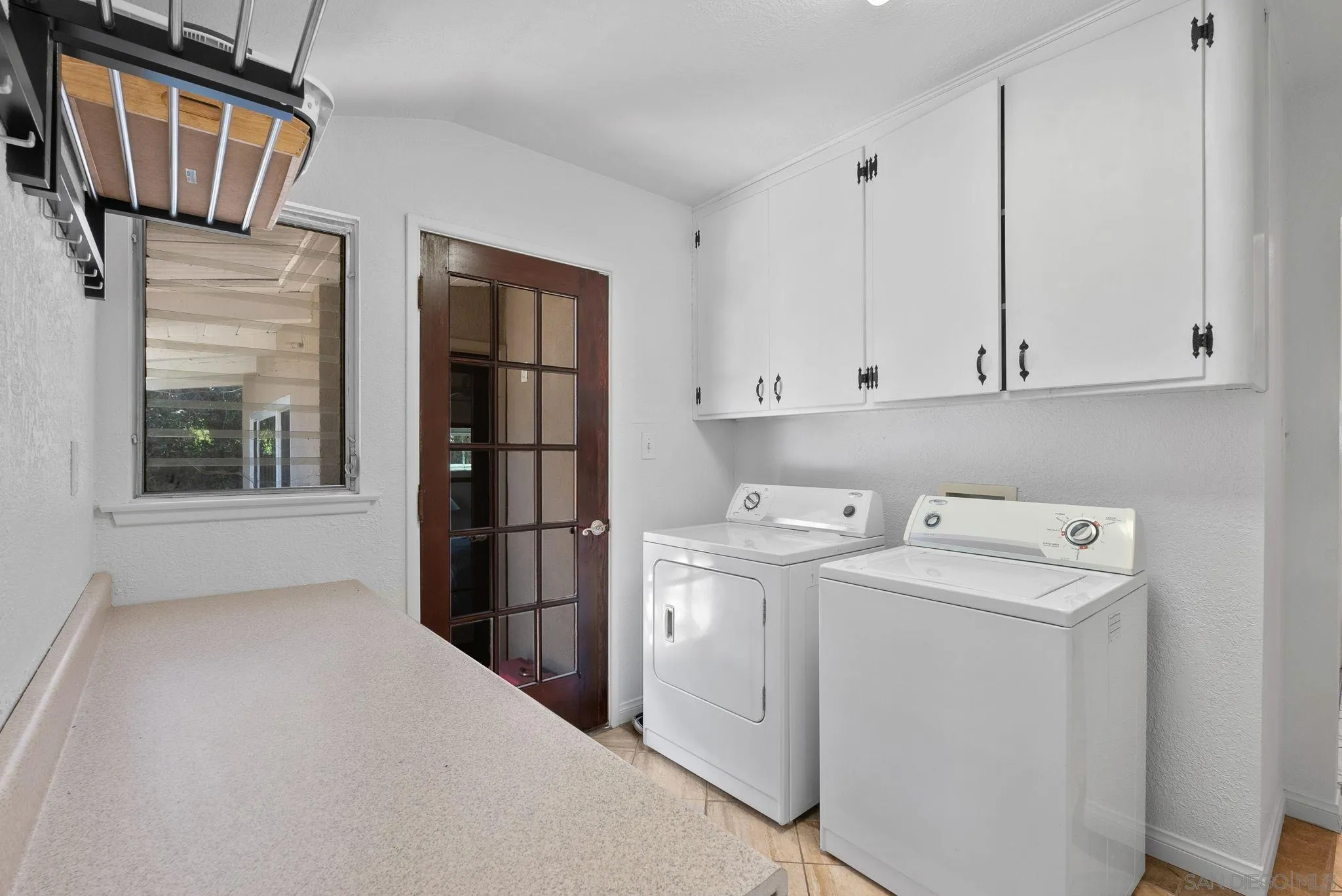 5492 Redding Road San Diego, CA 92115 - Photo 64 of 74 a view of storage and utility room with washer and dryer