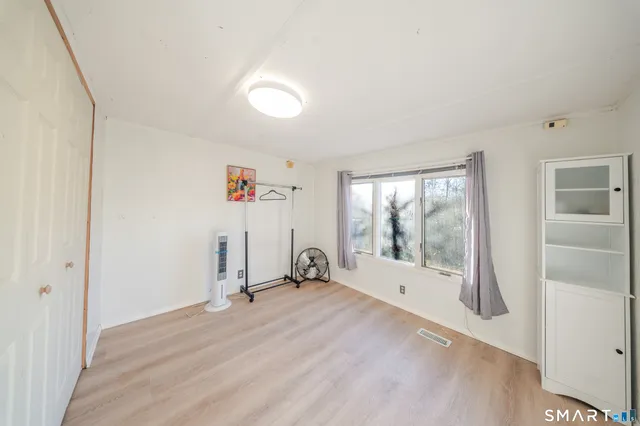 a view of a room with gym equipment and a large window