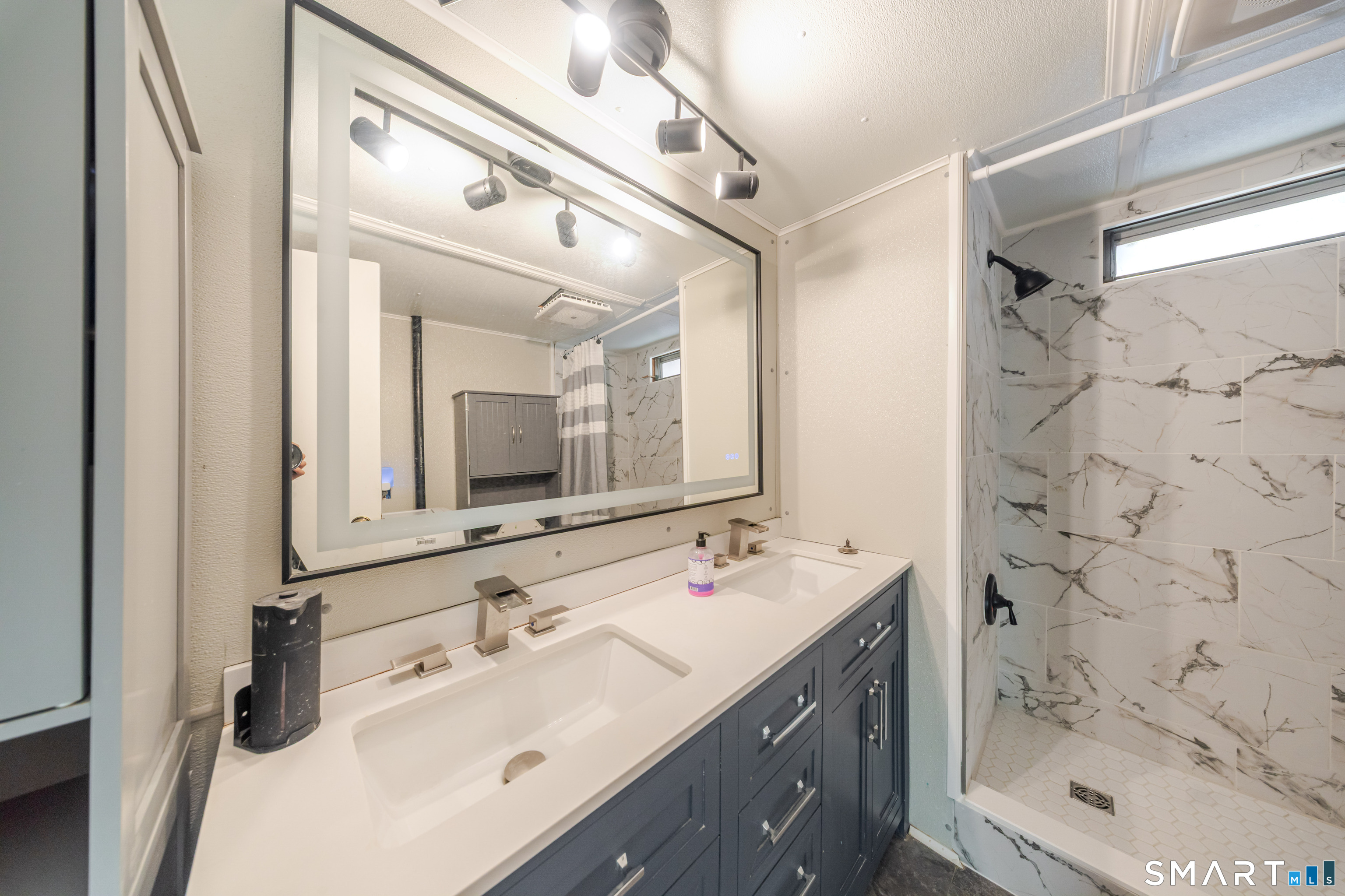 93 Shawnee Road East Hartford, CT 06118 - Photo 15 of 37 a bathroom with a double vanity sink mirror and shower