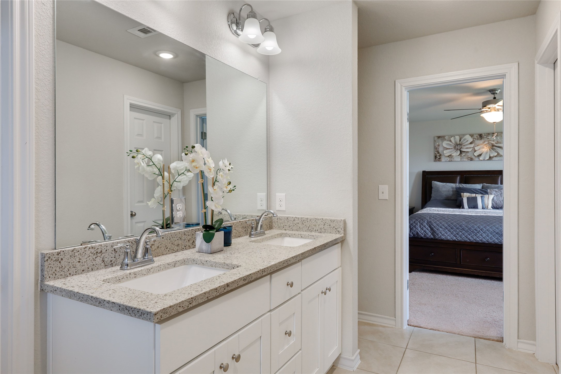 7404 Albany Drive Austin, TX 78754 - Photo 21 of 40 Also featuring a granite topped dual vanity with white cabinetry.
