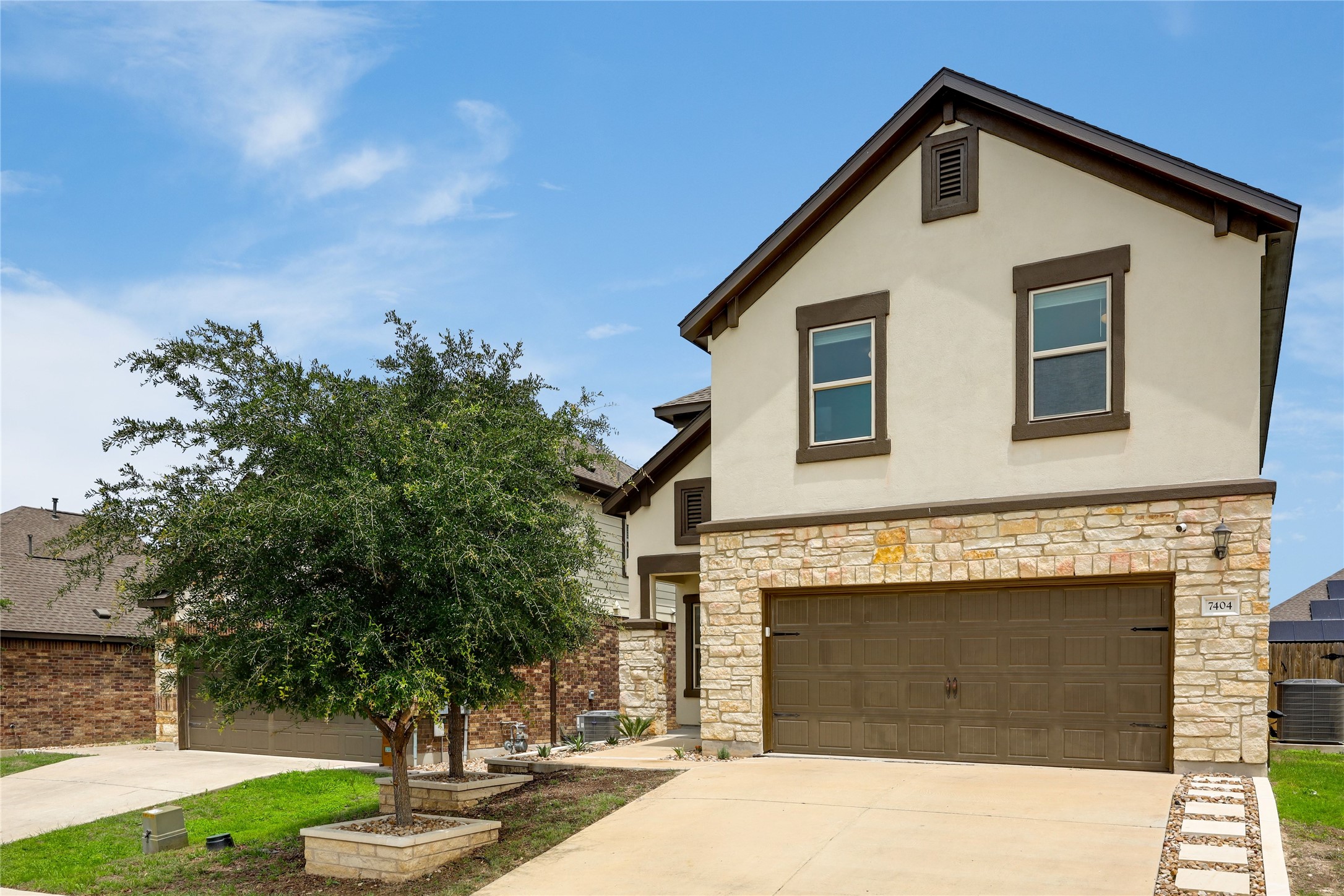 7404 Albany Drive Austin, TX 78754 - Photo 5 of 40 The freshly updated front yard features over $3,500 in professional landscaping, while the Smart Garage system adds modern convenience with remote myQ app control.