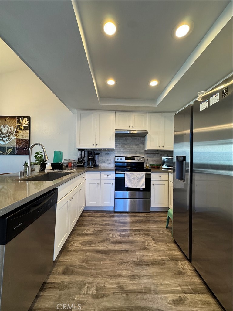3932 West 5th Street, Unit 202 Santa Ana, CA 92703 - Photo 1 of 12 a large kitchen with granite countertop a large counter top stainless steel appliances and cabinets