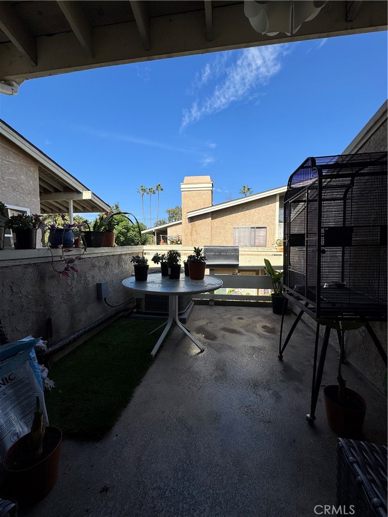 3932 West 5th Street, Unit 202 Santa Ana, CA 92703 - Photo 4 of 12 a view of a patio with table and chairs under an umbrella