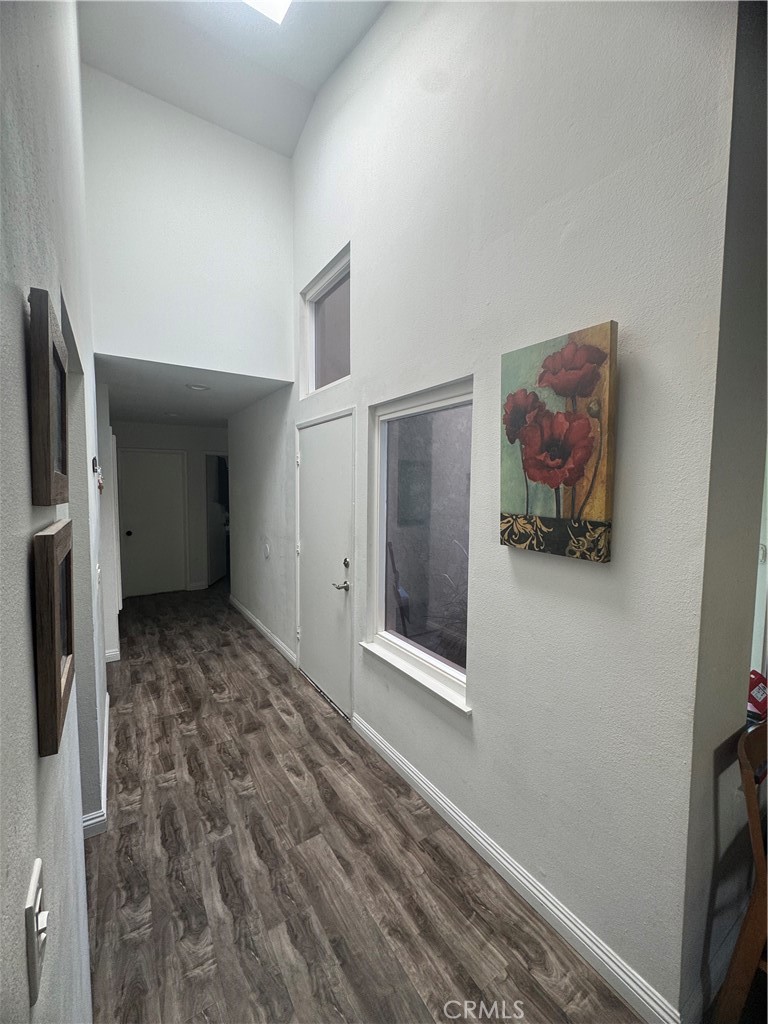 3932 West 5th Street, Unit 202 Santa Ana, CA 92703 - Photo 5 of 12 a view of hallway with window and a refrigerator
