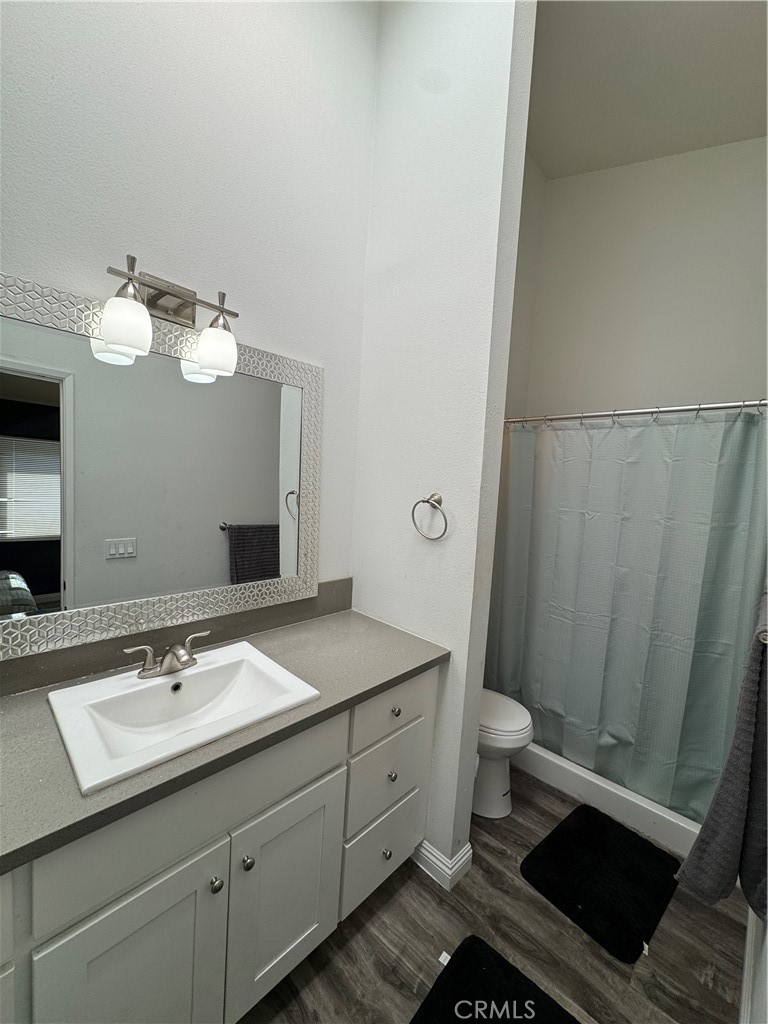 3932 West 5th Street, Unit 202 Santa Ana, CA 92703 - Photo 9 of 12 a bathroom with a sink a toilet and a mirror