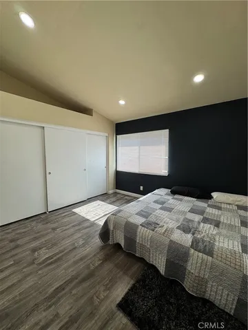 a bedroom with a bed and dresser