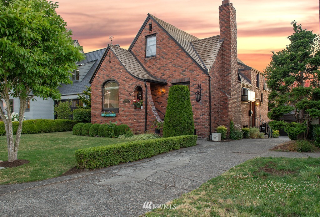 a front view of a house with a garden and plants