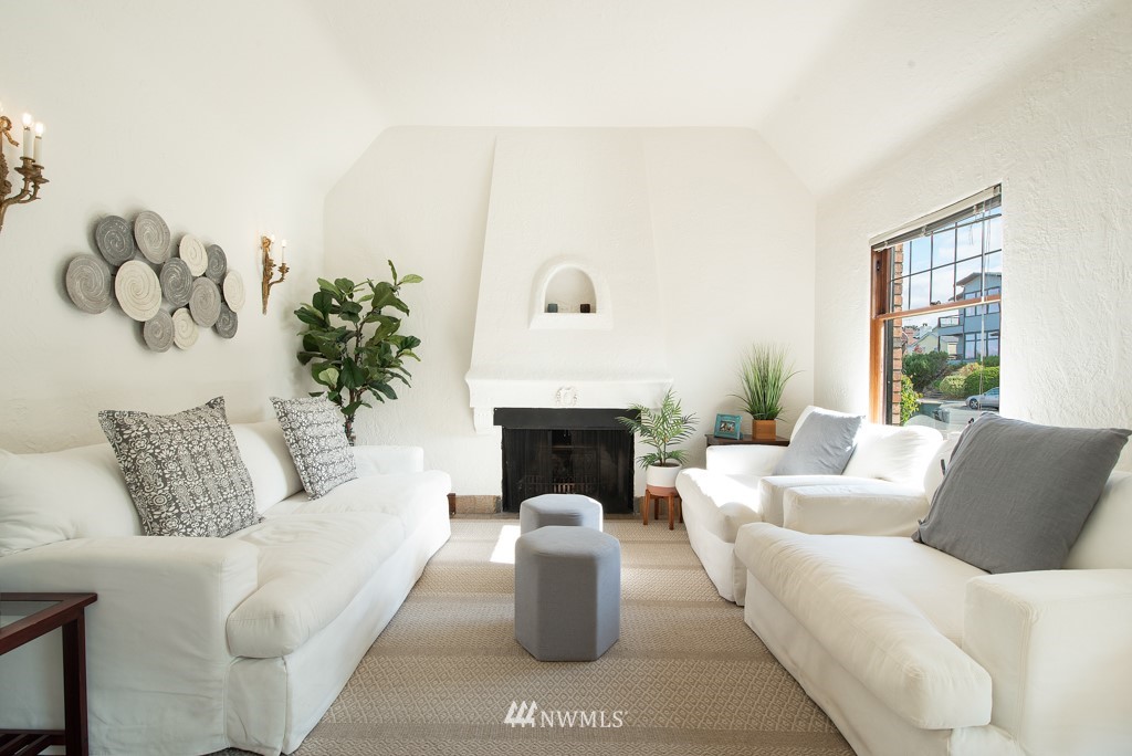 3011 West Viewmont Way West Seattle, WA 98199 - Photo 2 of 28 a living room with furniture a fireplace and potted plants