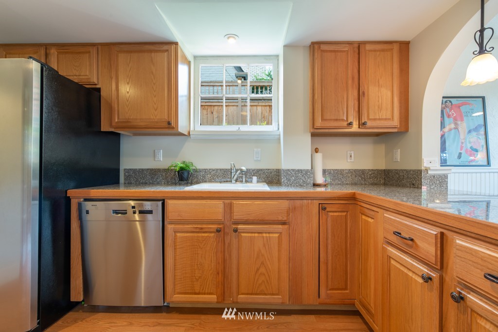 3011 West Viewmont Way West Seattle, WA 98199 - Photo 20 of 28 a kitchen with stainless steel appliances granite countertop a refrigerator sink and cabinets