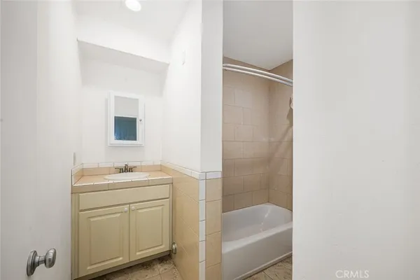 a bathroom with a tub and shower