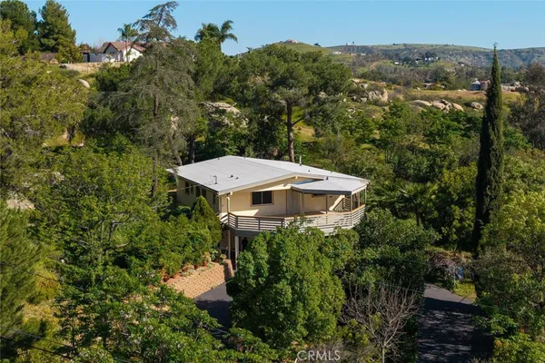 an aerial view of a house with yard and outdoor seating