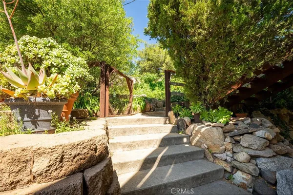 a view of a garden with an outdoor seating